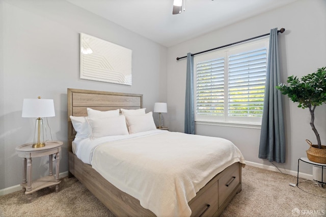 bedroom featuring light carpet, a ceiling fan, and baseboards