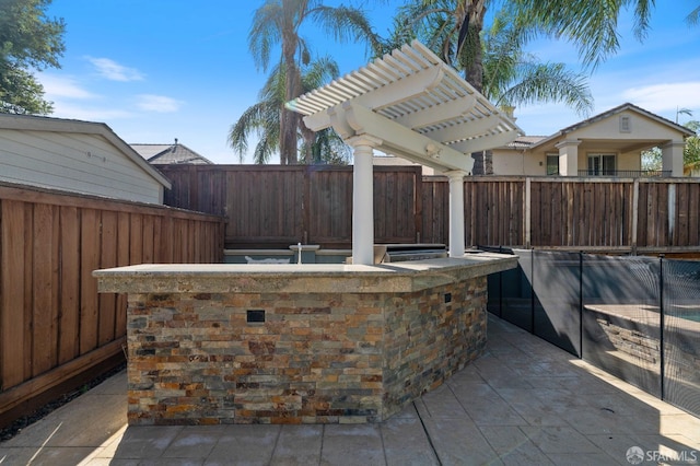 view of patio with a fenced backyard, a pergola, and area for grilling