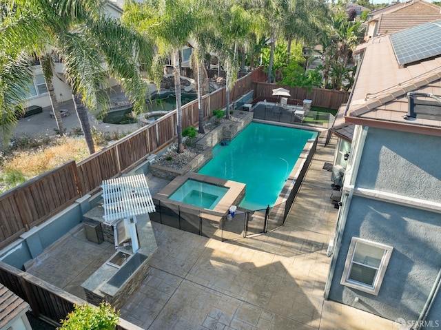 view of pool with a fenced backyard, a patio area, and a pool with connected hot tub