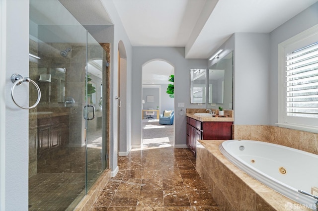 full bath with a wealth of natural light, vanity, and a stall shower