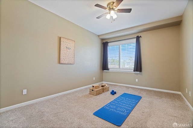 workout area featuring baseboards, a ceiling fan, and carpet flooring