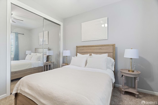 carpeted bedroom with a closet and baseboards