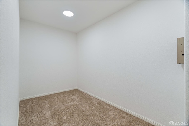 empty room featuring carpet floors and baseboards