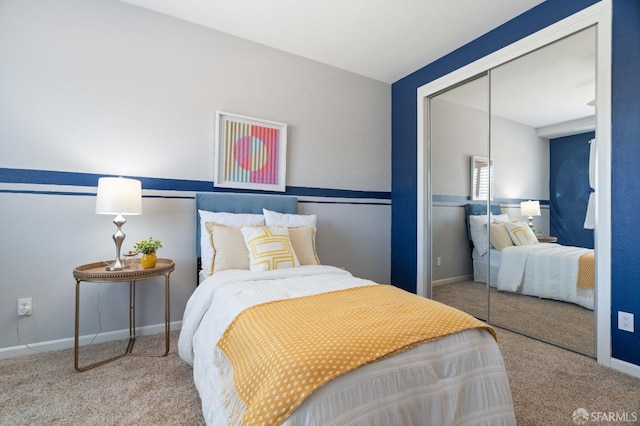 bedroom with baseboards, carpet flooring, and a closet