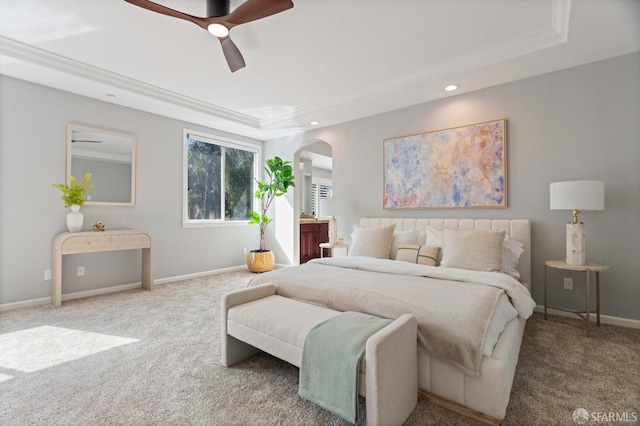 bedroom featuring arched walkways, a tray ceiling, baseboards, carpet flooring, and recessed lighting