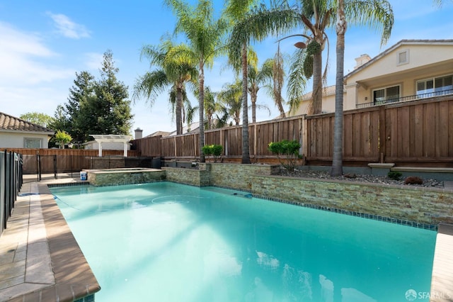 view of swimming pool featuring a fenced in pool, a fenced backyard, and an in ground hot tub