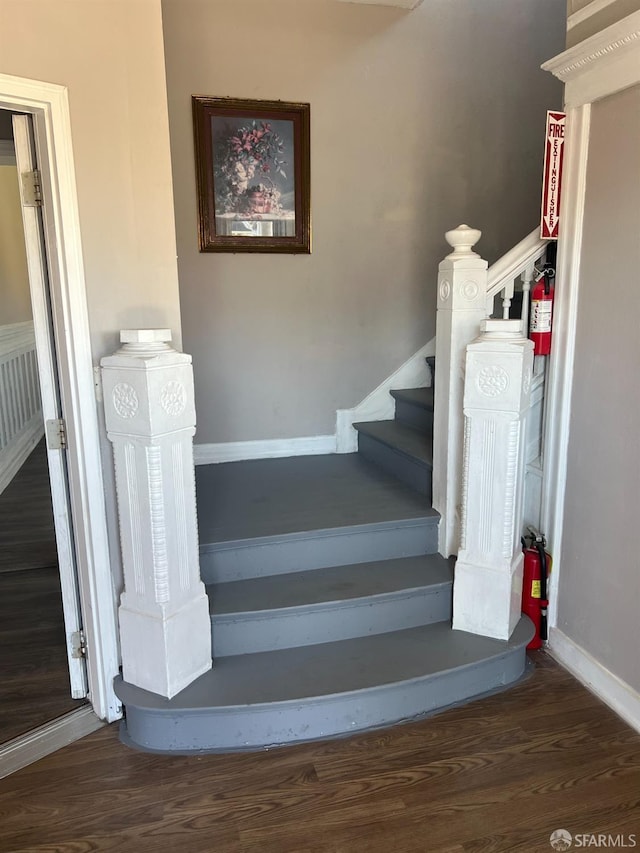 stairs featuring baseboards and wood finished floors