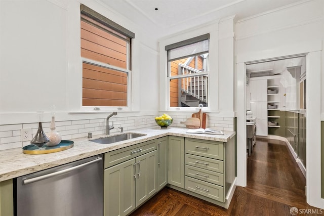 kitchen featuring sink, tasteful backsplash, stainless steel dishwasher, dark hardwood / wood-style floors, and green cabinets