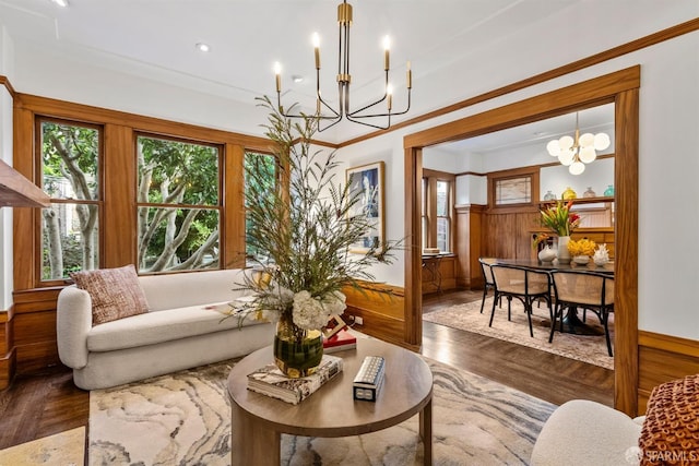 interior space featuring a notable chandelier, crown molding, dark hardwood / wood-style floors, and wood walls