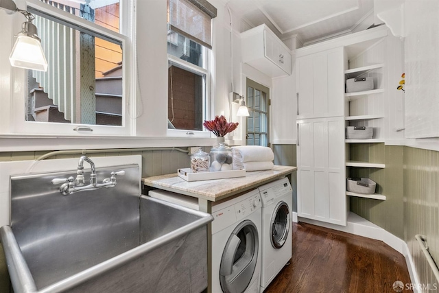 washroom featuring dark hardwood / wood-style floors, washer and clothes dryer, and sink