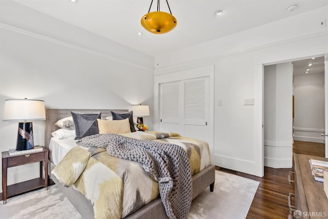 bedroom with hardwood / wood-style flooring and a closet