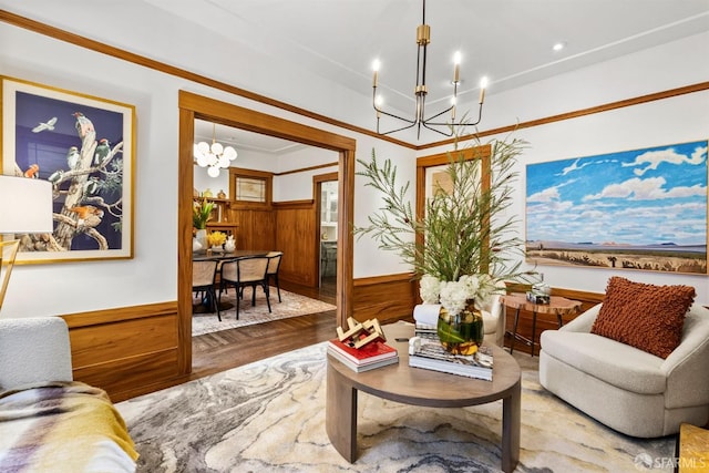 living area featuring hardwood / wood-style flooring, wooden walls, and a chandelier