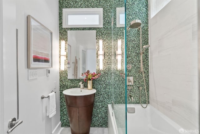 bathroom with vanity and shower / bath combination with glass door