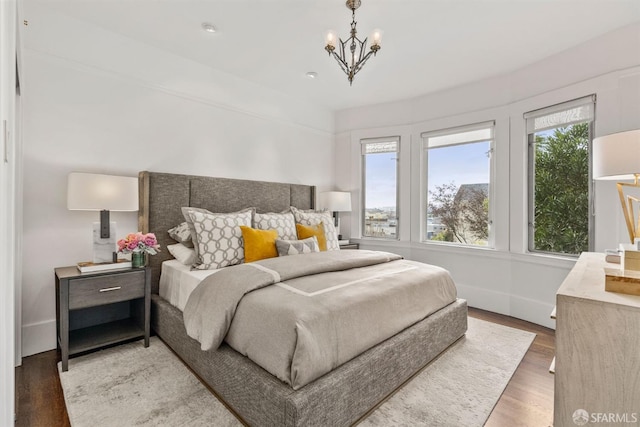 bedroom featuring hardwood / wood-style floors and a notable chandelier