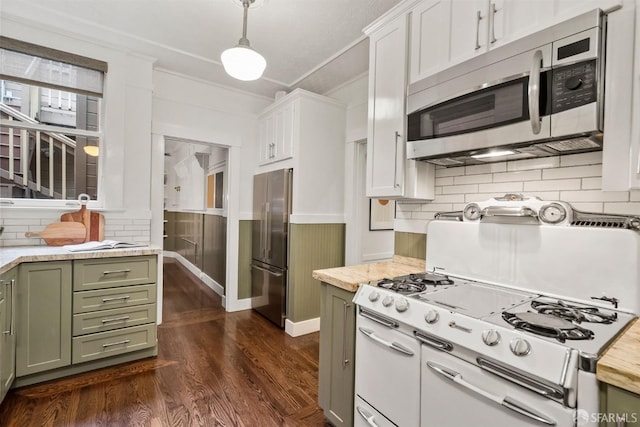 kitchen featuring pendant lighting, dark wood-type flooring, green cabinets, appliances with stainless steel finishes, and white cabinets