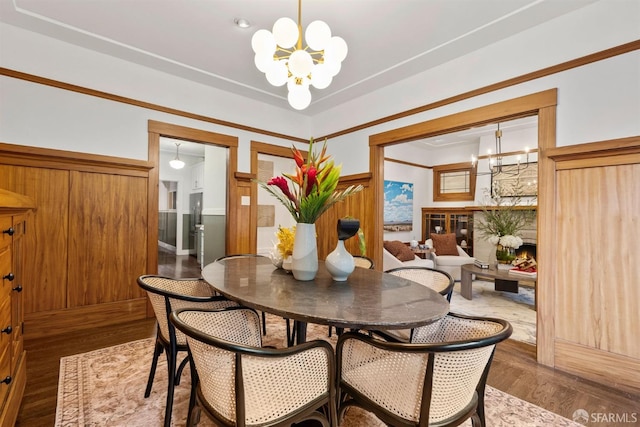 dining space with dark hardwood / wood-style floors and a notable chandelier