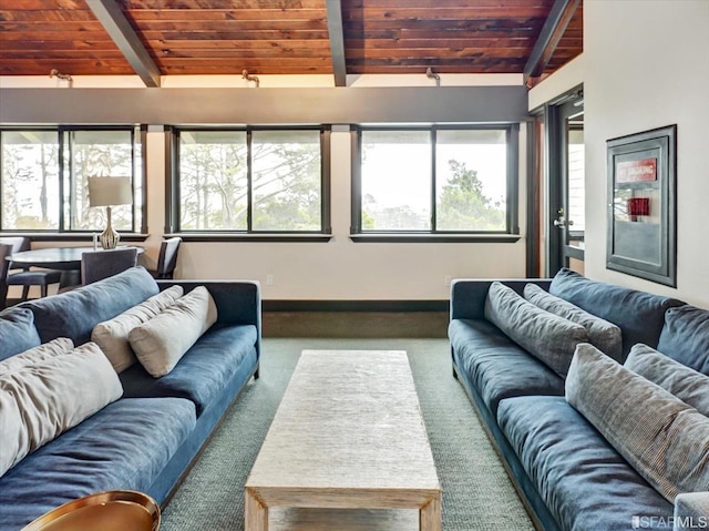 living room featuring vaulted ceiling with beams, a healthy amount of sunlight, and wood ceiling