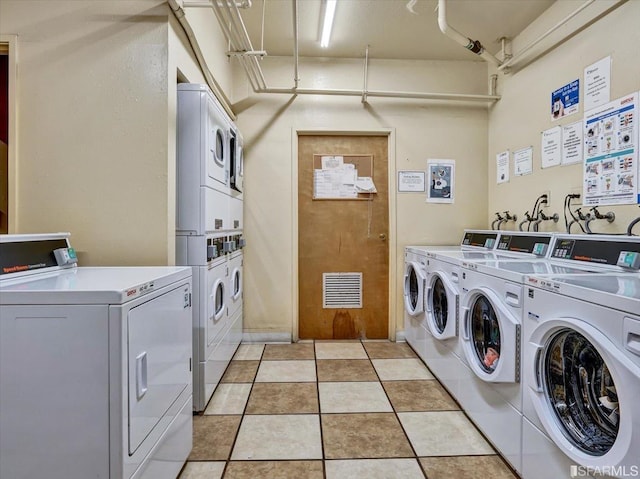 laundry room with washing machine and dryer, light tile patterned floors, and stacked washer and clothes dryer