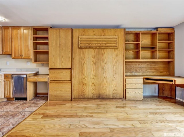 kitchen with dishwasher, built in desk, and light hardwood / wood-style flooring