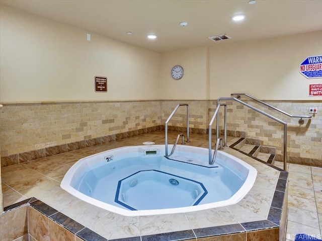 view of swimming pool with an indoor in ground hot tub