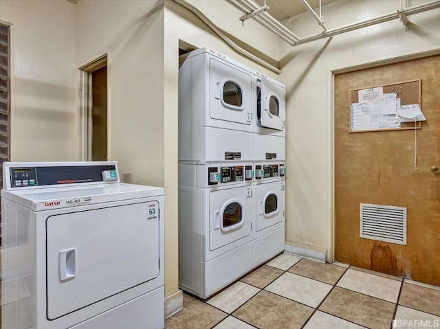 laundry room featuring stacked washing maching and dryer and washing machine and clothes dryer