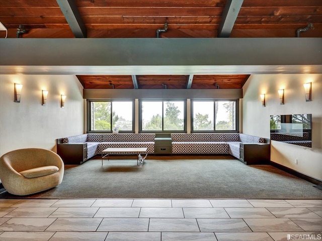 unfurnished living room with vaulted ceiling with beams, wood ceiling, and a wealth of natural light