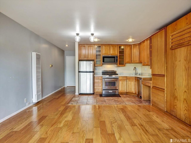 kitchen featuring light hardwood / wood-style floors, sink, and appliances with stainless steel finishes