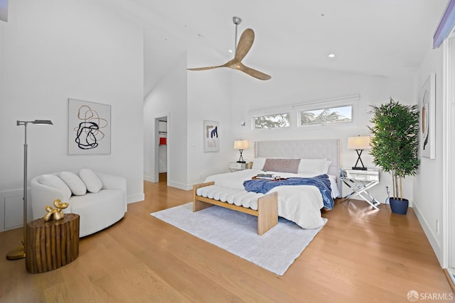 bedroom featuring baseboards, ceiling fan, high vaulted ceiling, and wood finished floors