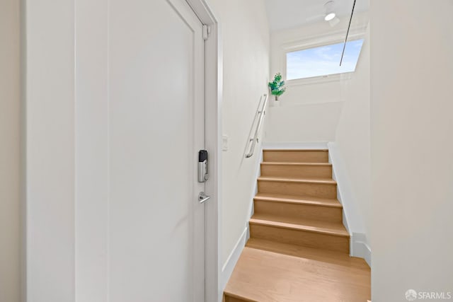 staircase with wood finished floors