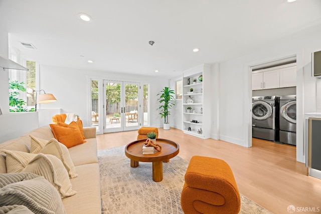 living area featuring light wood-style floors, recessed lighting, french doors, and washing machine and clothes dryer