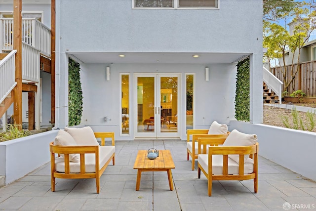 view of patio / terrace featuring stairs, an outdoor living space, and french doors