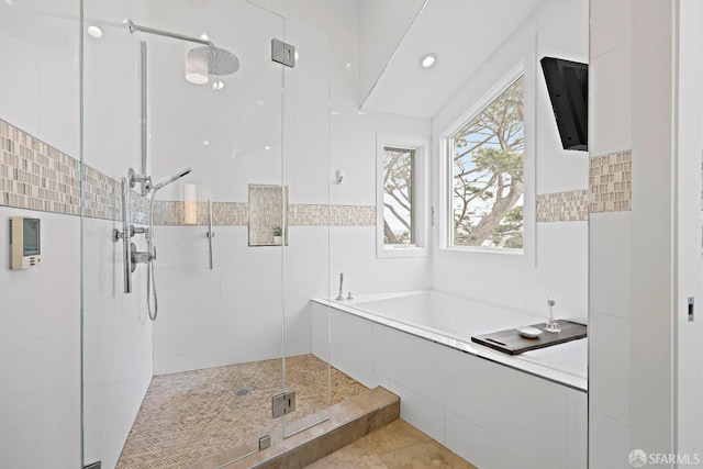 full bathroom with a stall shower, tile patterned flooring, and a garden tub