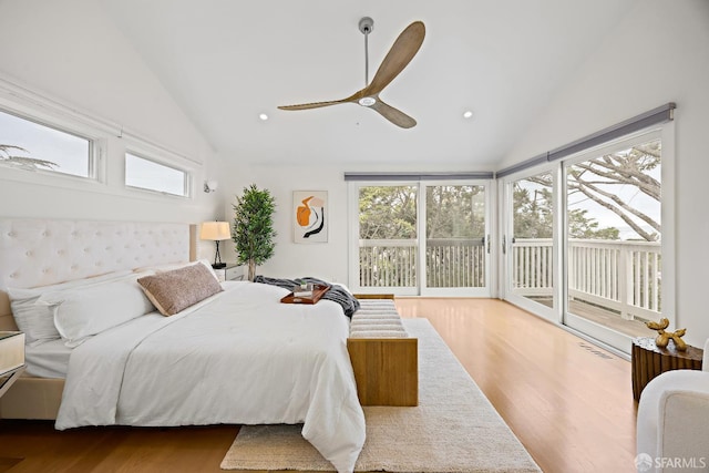 bedroom featuring lofted ceiling, multiple windows, and access to exterior