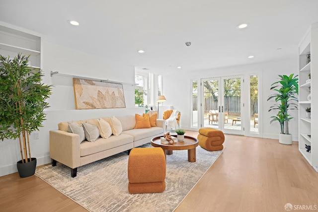 living area with light wood finished floors, recessed lighting, baseboards, and french doors