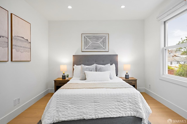 bedroom featuring baseboards, recessed lighting, and light wood-style floors