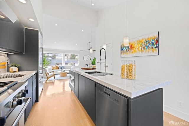 kitchen with a sink, dark cabinets, modern cabinets, and dishwasher