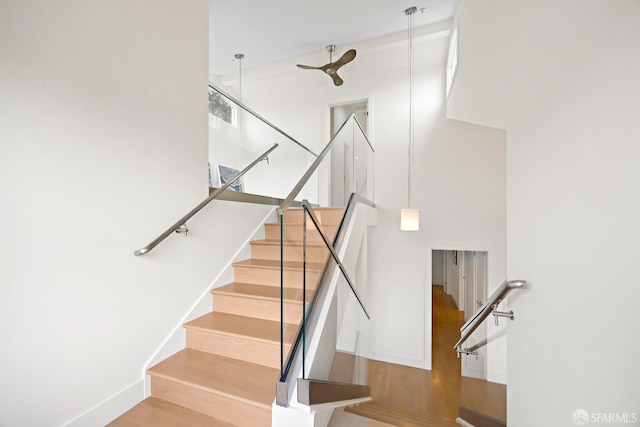 stairway featuring wood finished floors and baseboards