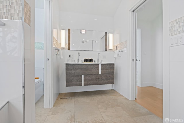 bathroom with backsplash, visible vents, and vanity