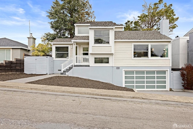 view of front of property featuring an attached garage, fence, and stucco siding