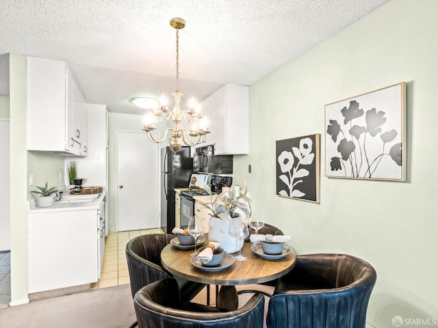 tiled dining room featuring sink, a textured ceiling, and a chandelier