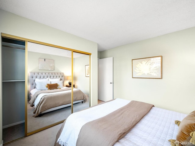 carpeted bedroom featuring a closet and a textured ceiling