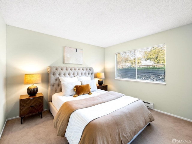 carpeted bedroom featuring a textured ceiling and a baseboard heating unit