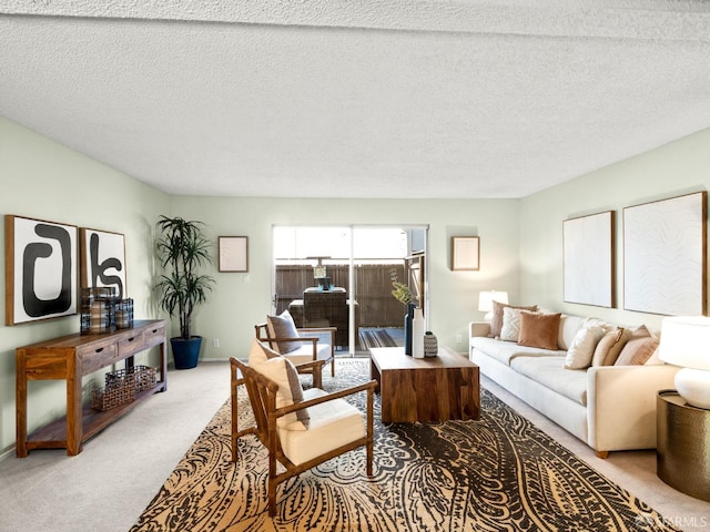 carpeted living room featuring a textured ceiling