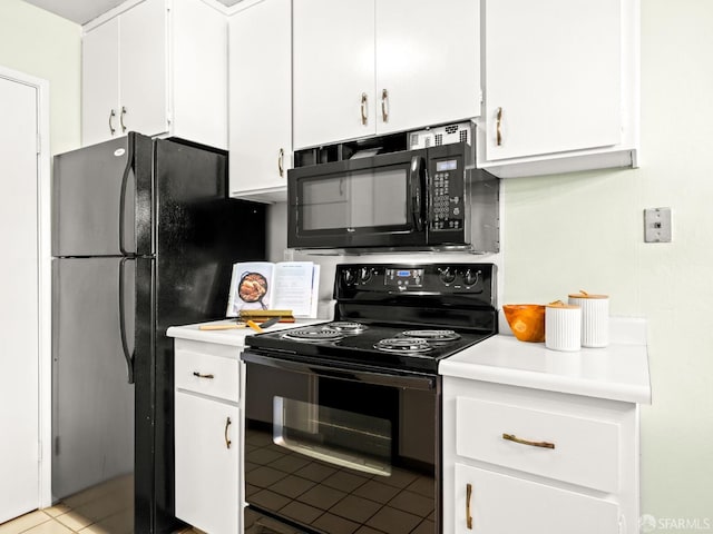 kitchen with white cabinets, light tile patterned floors, and black appliances