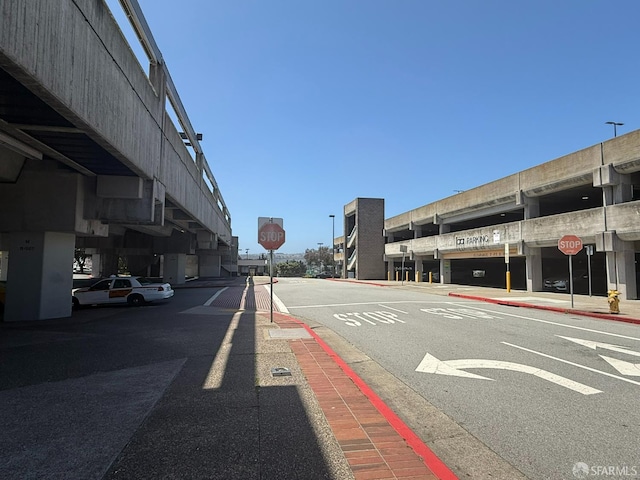 8100 Oceanview Ter Unit 117, San Francisco, CA 94132 - view of asphalt road featuring traffic signs, sidewalks, and curbs