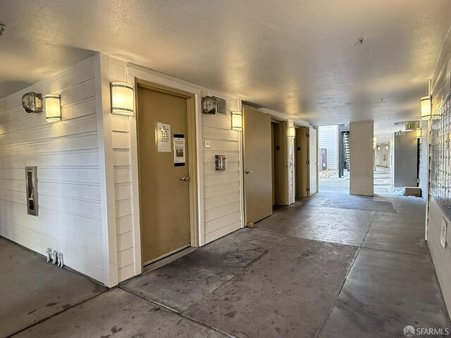 8100 Oceanview Ter Unit 117, San Francisco, CA 94132 - hall with unfinished concrete floors and a textured ceiling