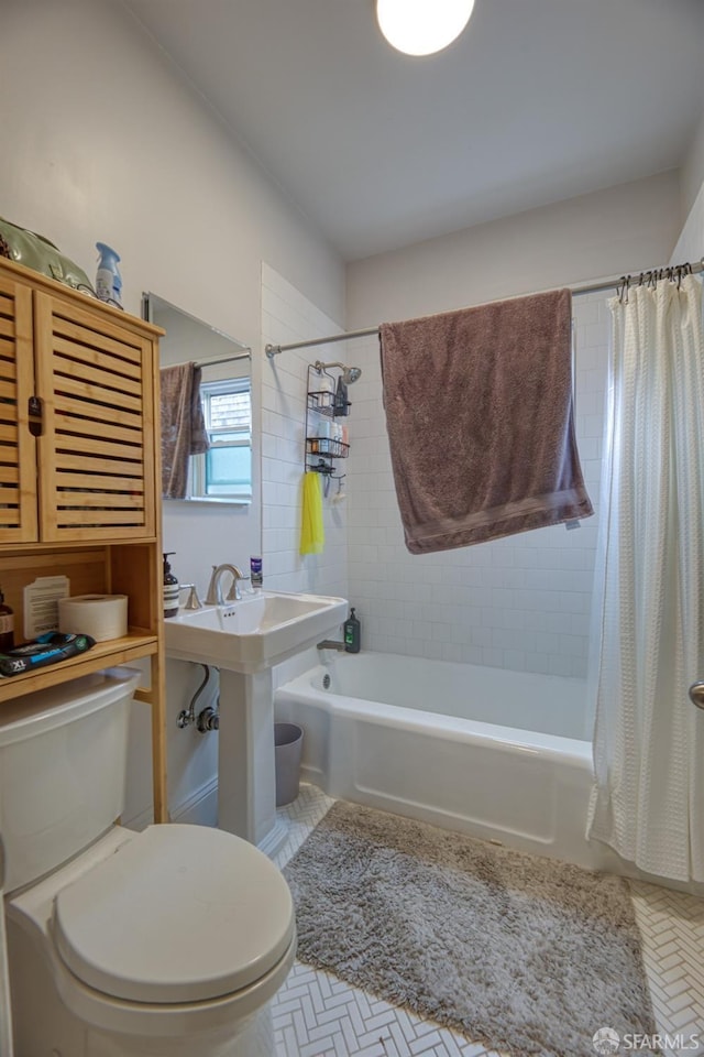 full bathroom featuring sink, shower / bath combination with curtain, and toilet