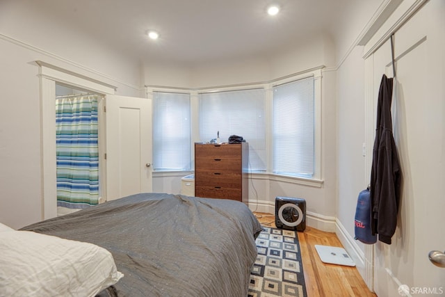 bedroom featuring a closet and light wood-type flooring