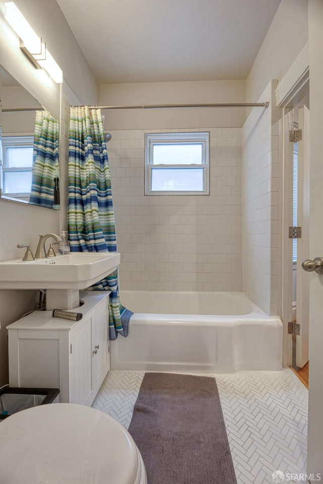 full bathroom with shower / tub combo, sink, tile patterned floors, and toilet