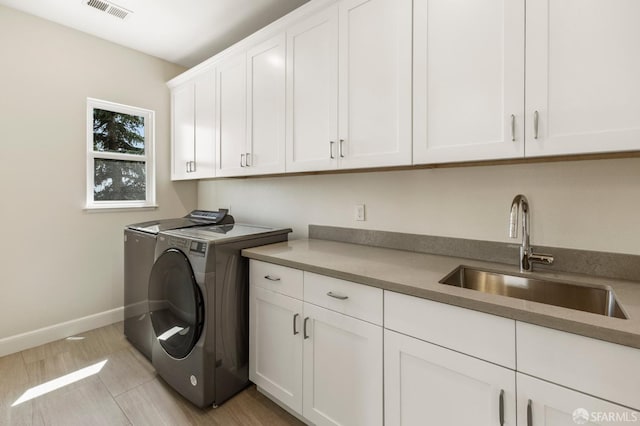 42119 Vinha Way, Fremont, CA 94539 - laundry area featuring cabinet space, washing machine and clothes dryer, baseboards, and light tile patterned floors